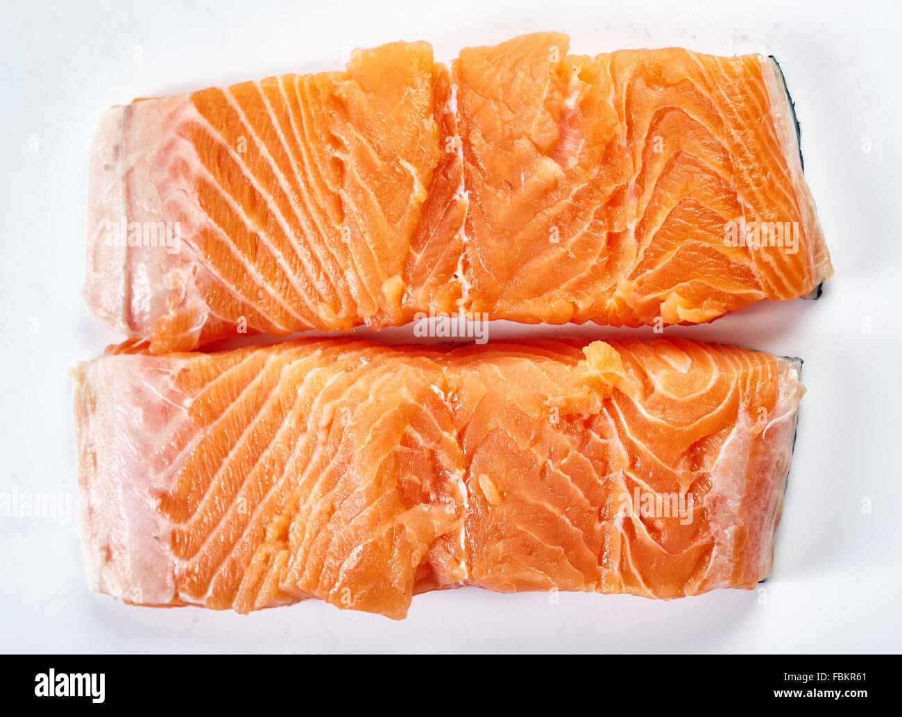 Closeup of raw salmon fillets on white background Stock Photo - Alamy
