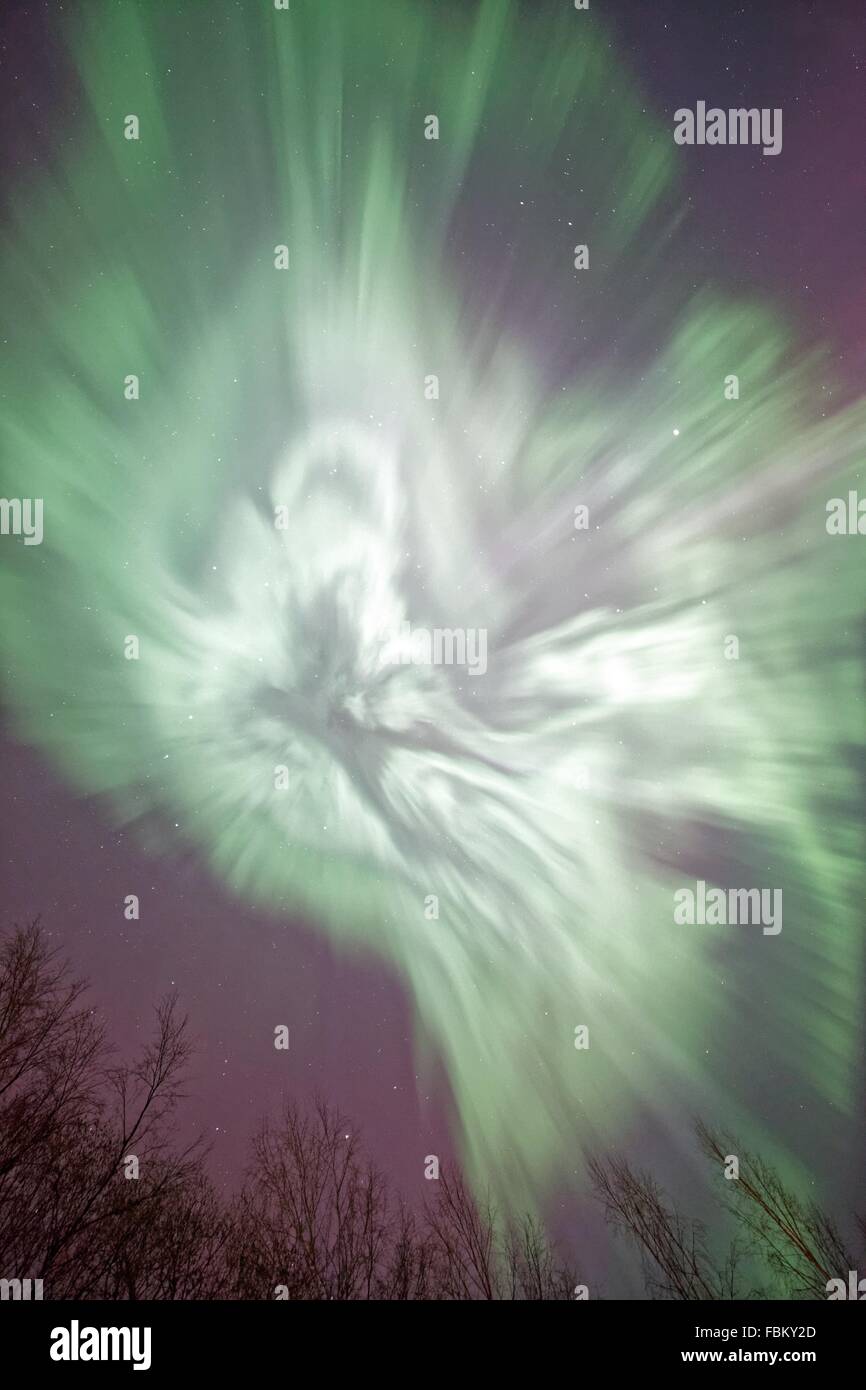 Northern lights (Aurora Borealis) glowing in the night sky over a icy ...