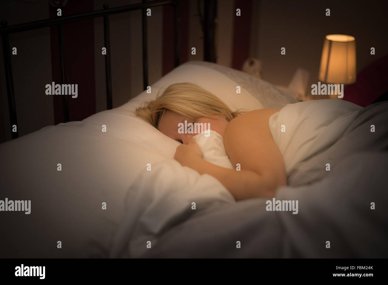A woman asleep in bed Stock Photo