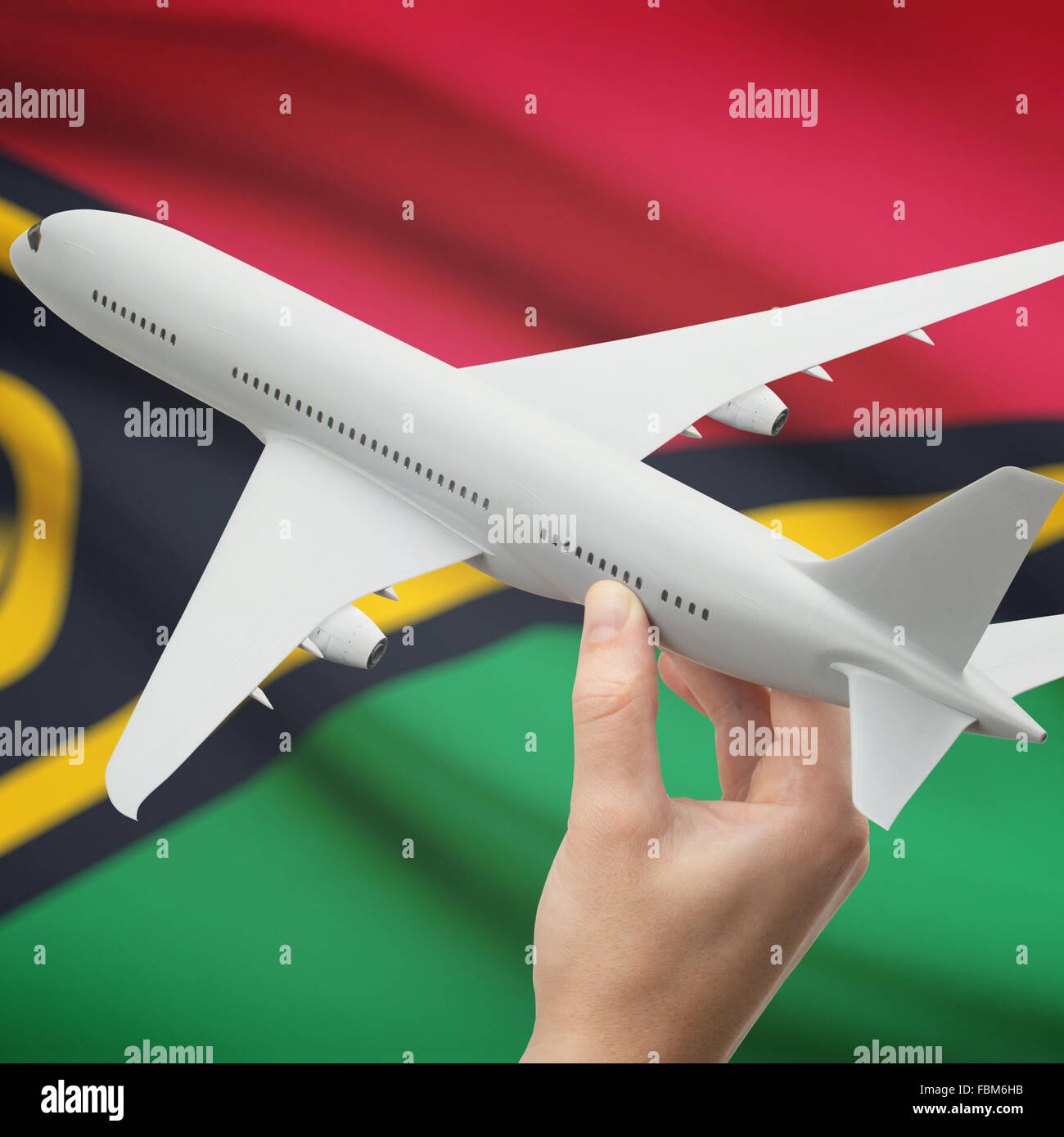 Airplane in hand with national flag on background series - Vanuatu Stock Photo