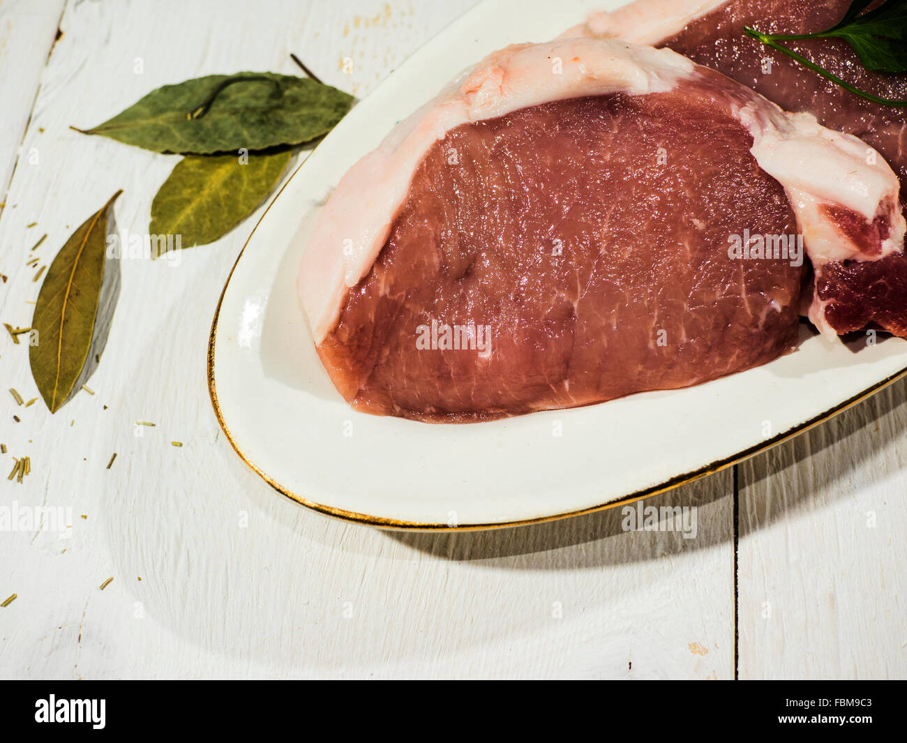 Raw pork chops on a plate Stock Photo