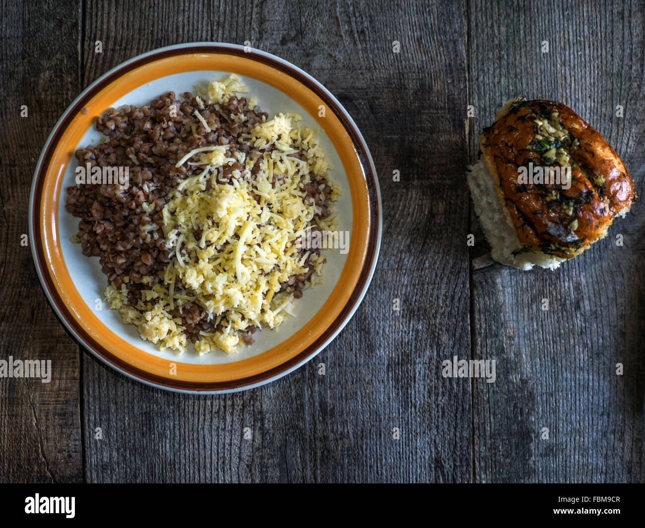 Buckwheat porridge with grated cheese on a plate Stock Photo