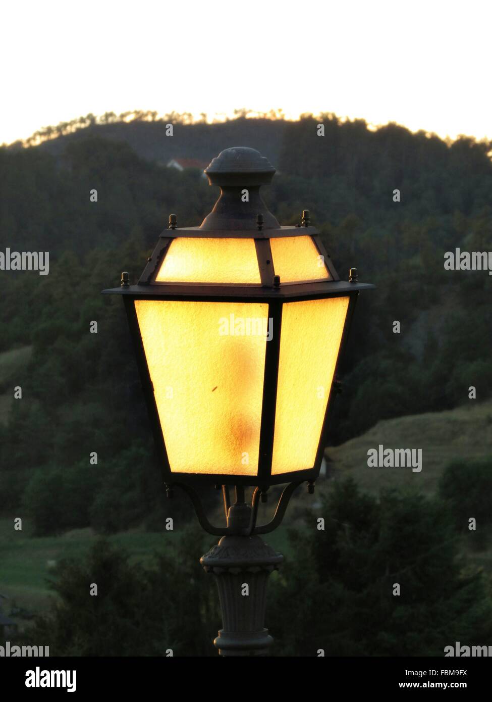 Ornate Lamp With Hills In Background Stock Photo