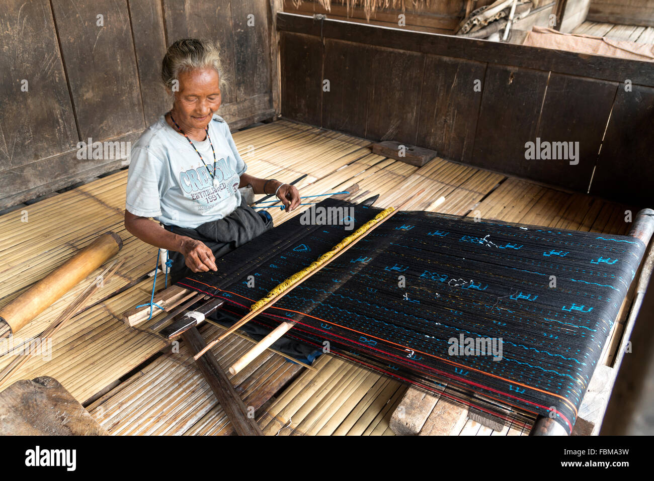 elderly woman weaving Ikat  in the traditional Ngada village Bena near Bajawa, Flores, Indonesia, Asia Stock Photo