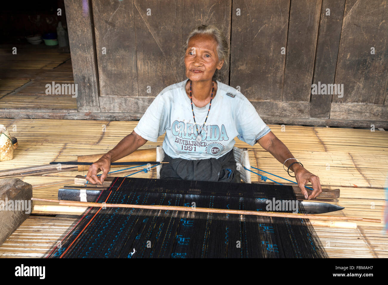 elderly woman weaving Ikat  in the traditional Ngada village Bena near Bajawa, Flores, Indonesia, Asia Stock Photo