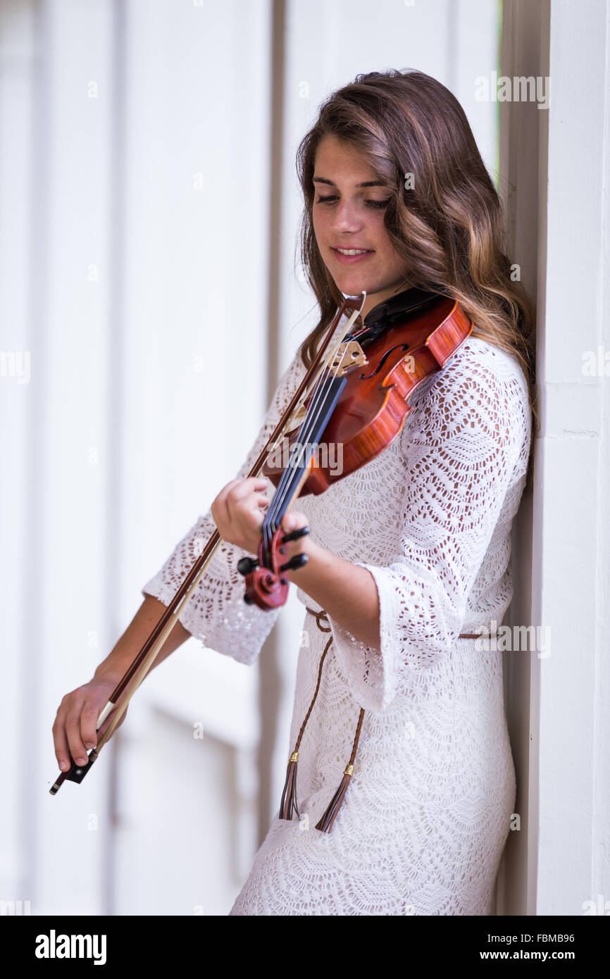Teenage girl Playing a violin Stock Photo