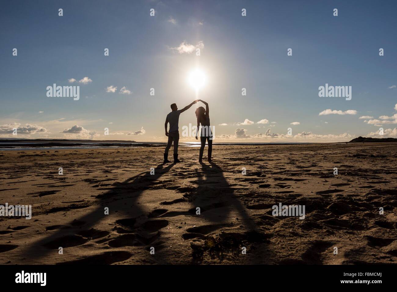 Silhouette of a couple dancing on the beach Stock Photo - Alamy