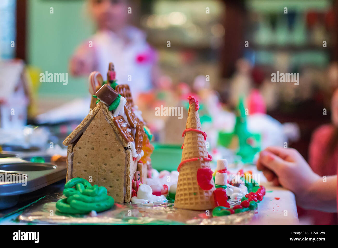 Children decorating gingerbread houses Stock Photo