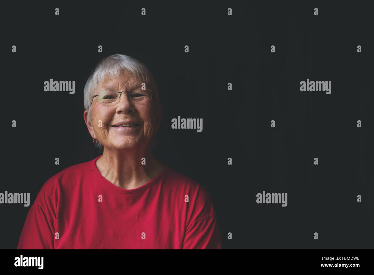 Portrait of a senior woman smiling Stock Photo - Alamy