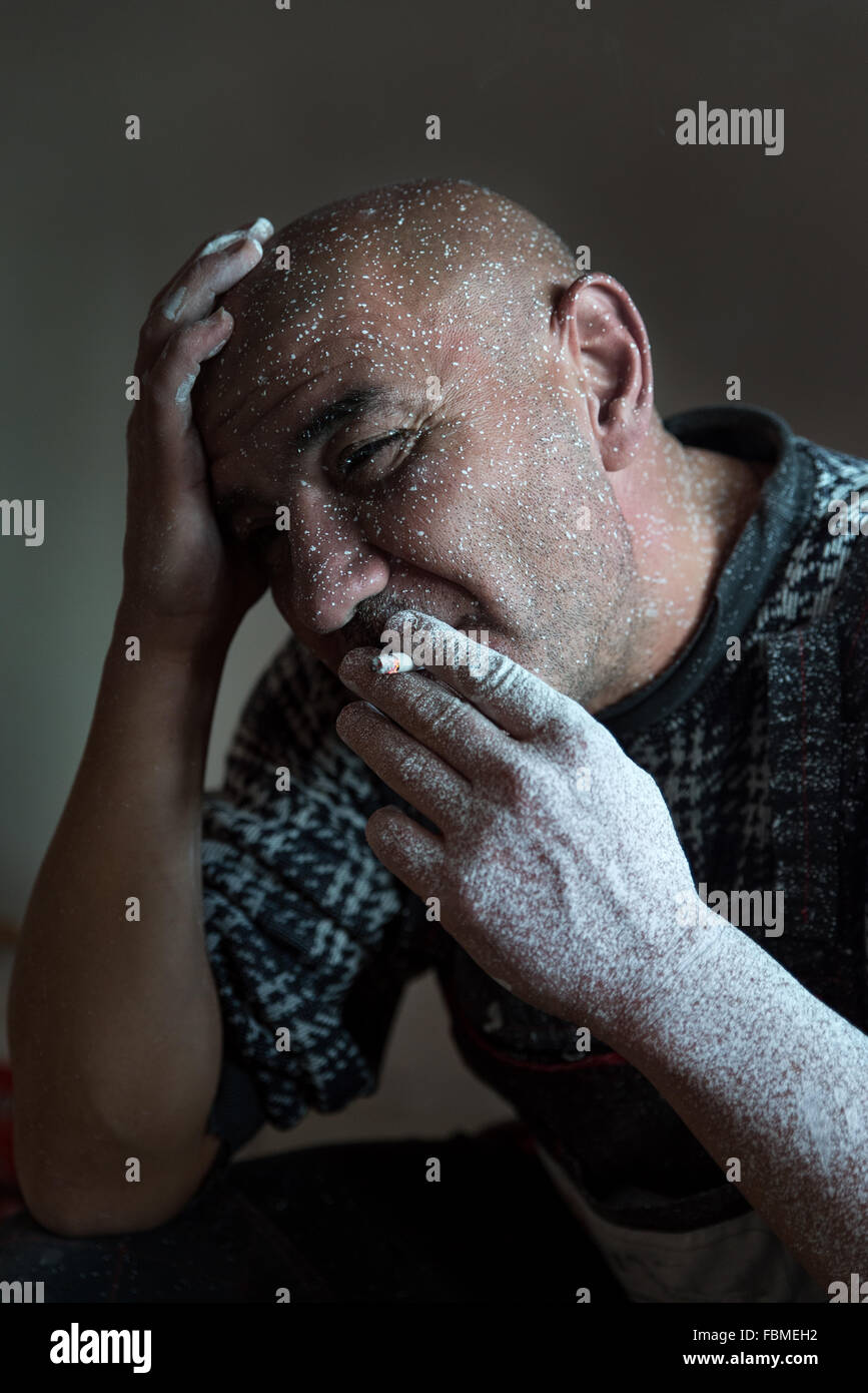 Man covered in paint smoking cigarette Stock Photo Alamy