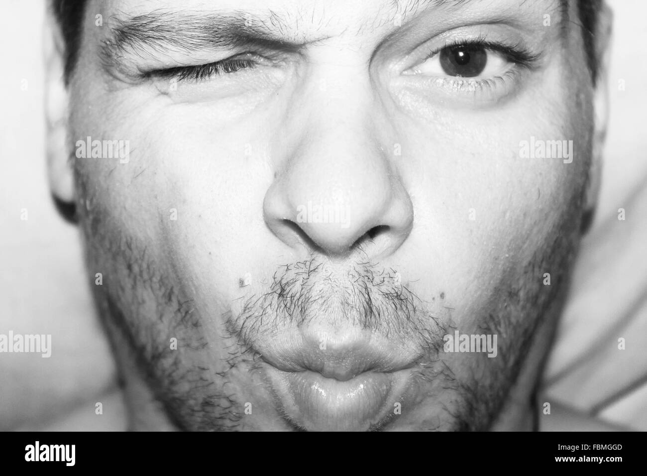 Portrait Of Man With One Eye Closed Stock Photo Alamy