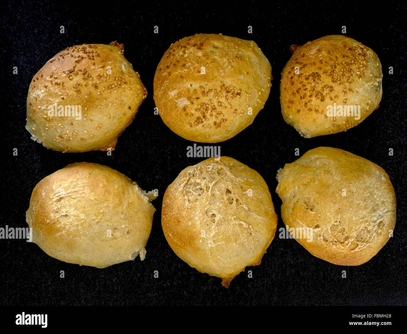 Six fresh bread rolls in rows Stock Photo