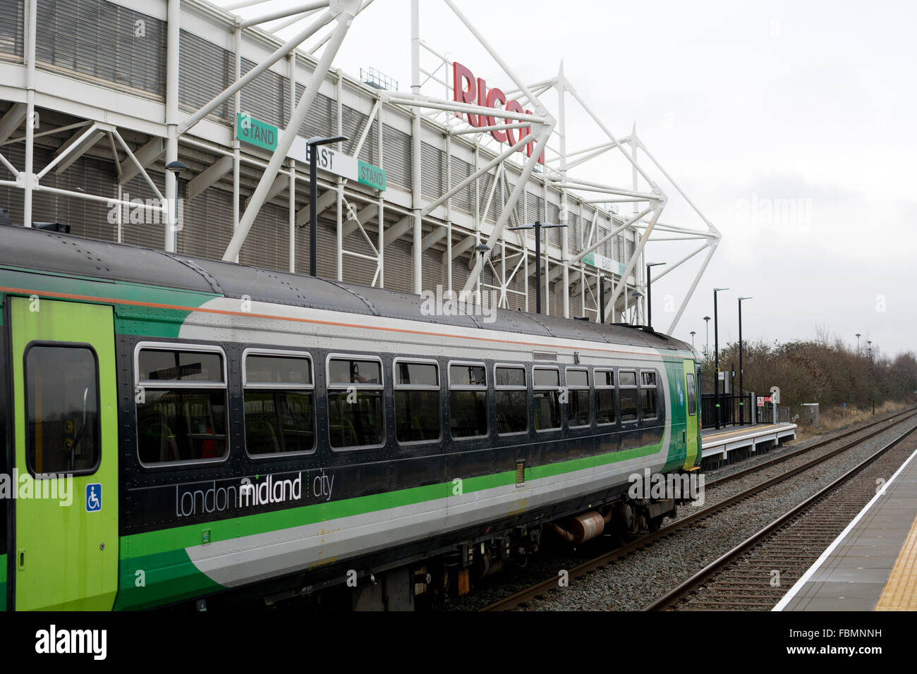 Coventry, UK. 18th January, 2016. A London Midland service from Coventry to Nuneaton stops at Coventry Arena railway station on its official opening day. Another station, Bermuda Park on the same line is also officially opened on this day forming part of a multi-million pound scheme to develop trainsport links between Coventry and Nuneaton. The Coventry Arena station is adjacent to the Ricoh Arena, home of Coventry City Football Club and Wasps rugby team, and the Arena Retail Park. Credit:  Colin Underhill/Alamy Live News Stock Photo