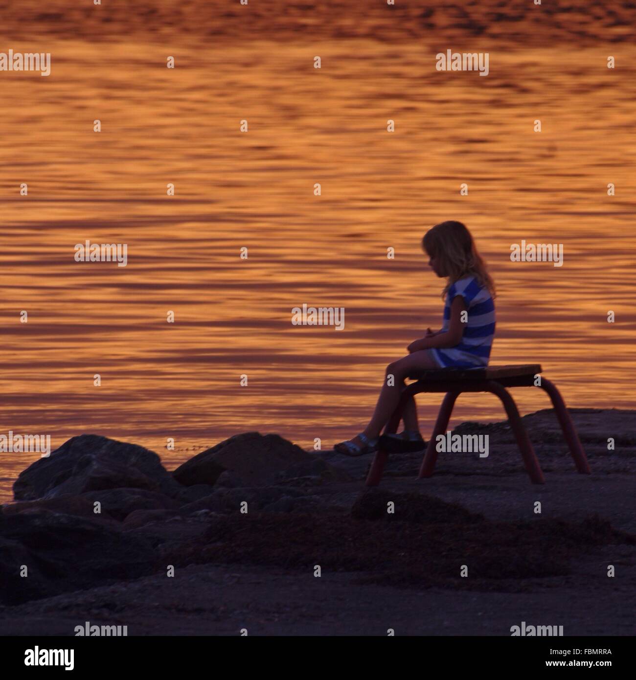 Girl sitting on bench hi-res stock photography and images - Alamy