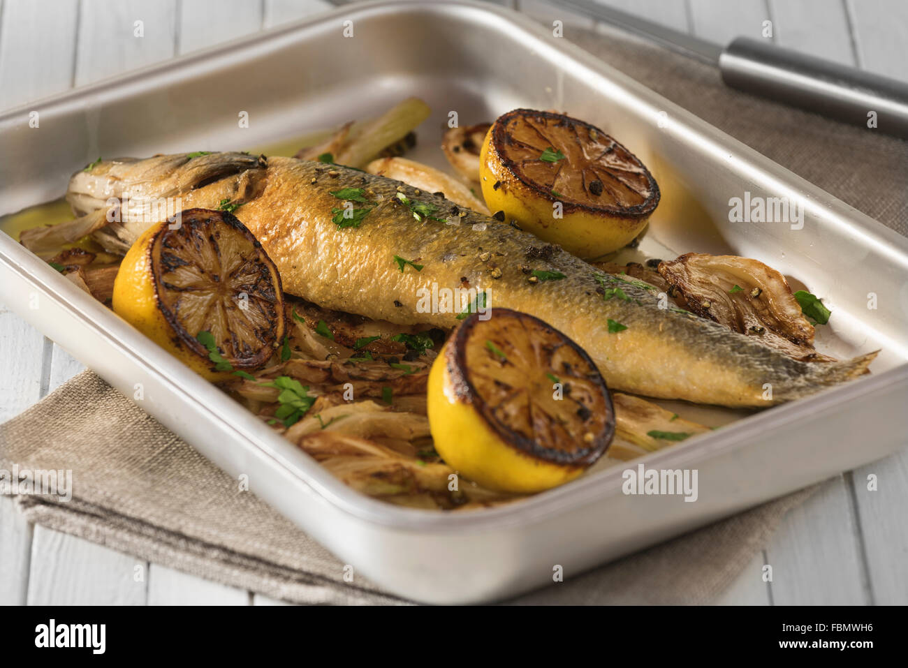 Baked sea bass with fennel and lemon Stock Photo