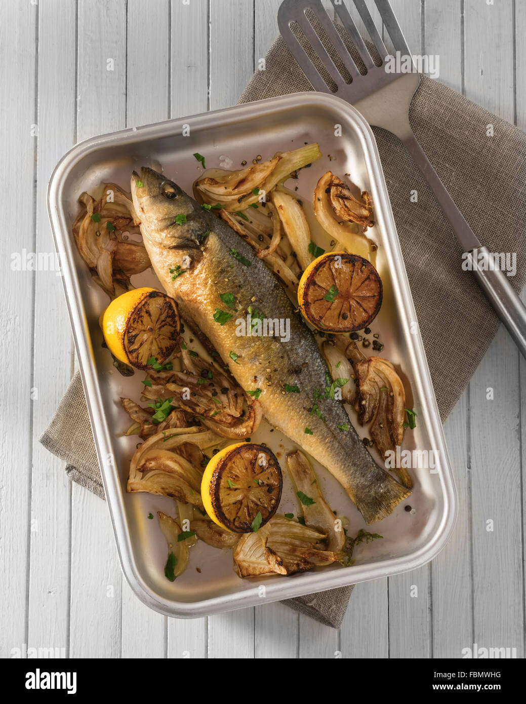 Baked sea bass with fennel and lemon Stock Photo