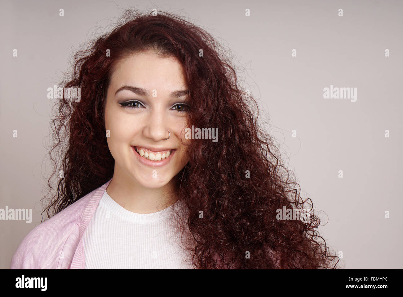 smiling teenage girl with curly hair Stock Photo - Alamy