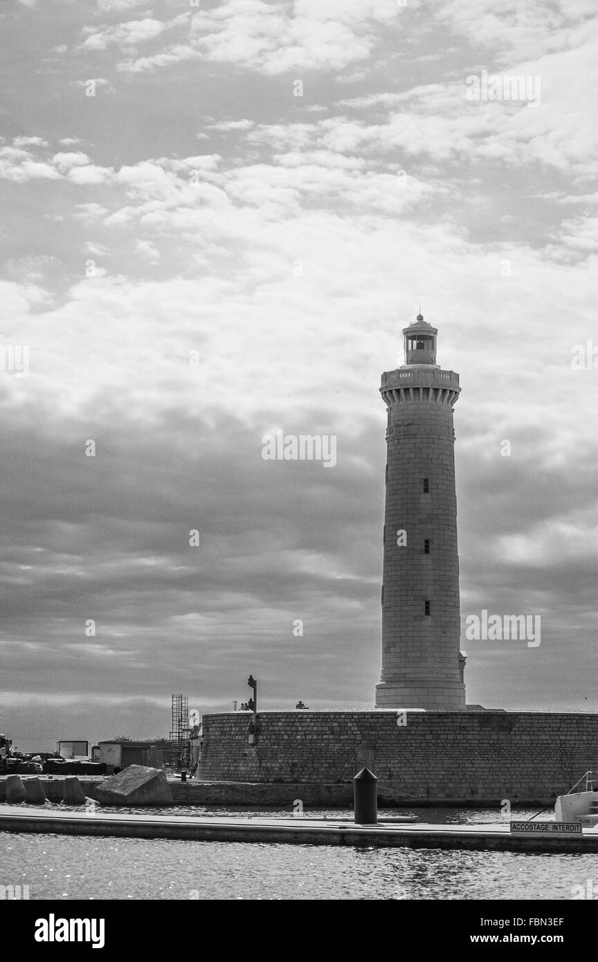 Lighthouse Against Cloudy Sky Stock Photo