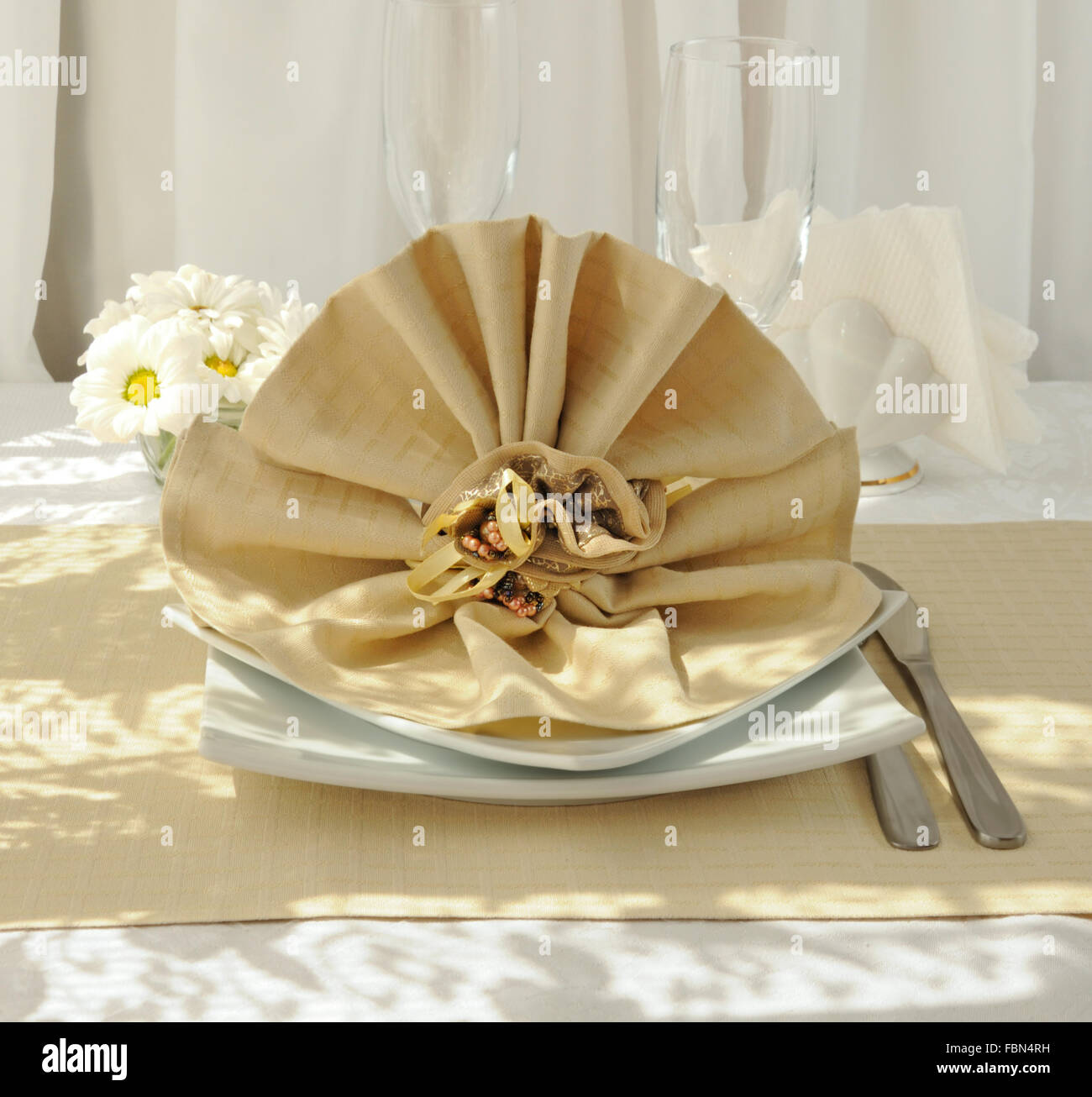 Coordinated decorative napkin on a plate with cutlery Stock Photo Alamy