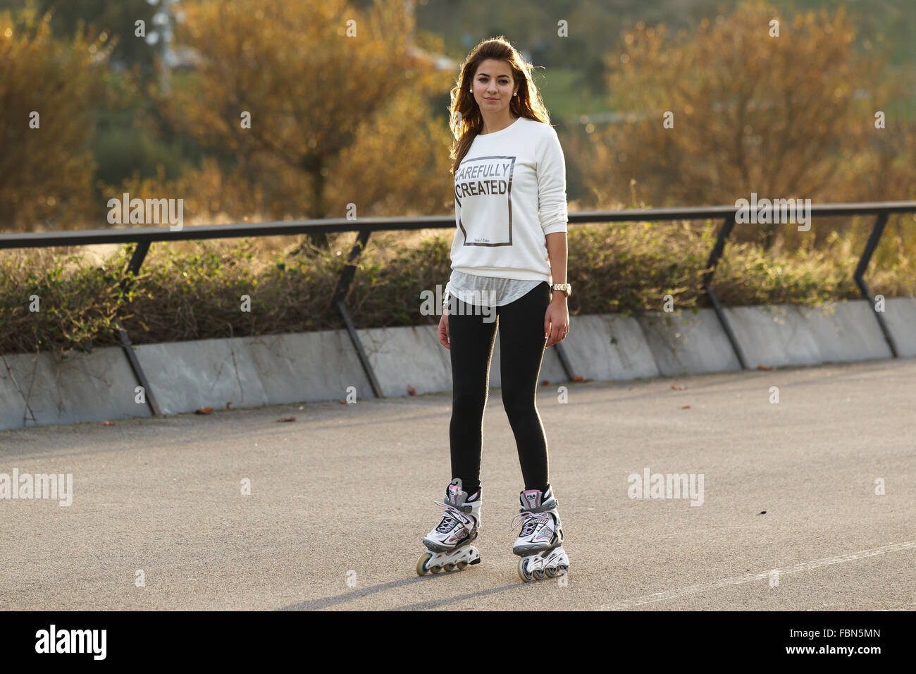 A caucasian young woman practicing inline skating in Santander, Cantabria, Spain. Stock Photo