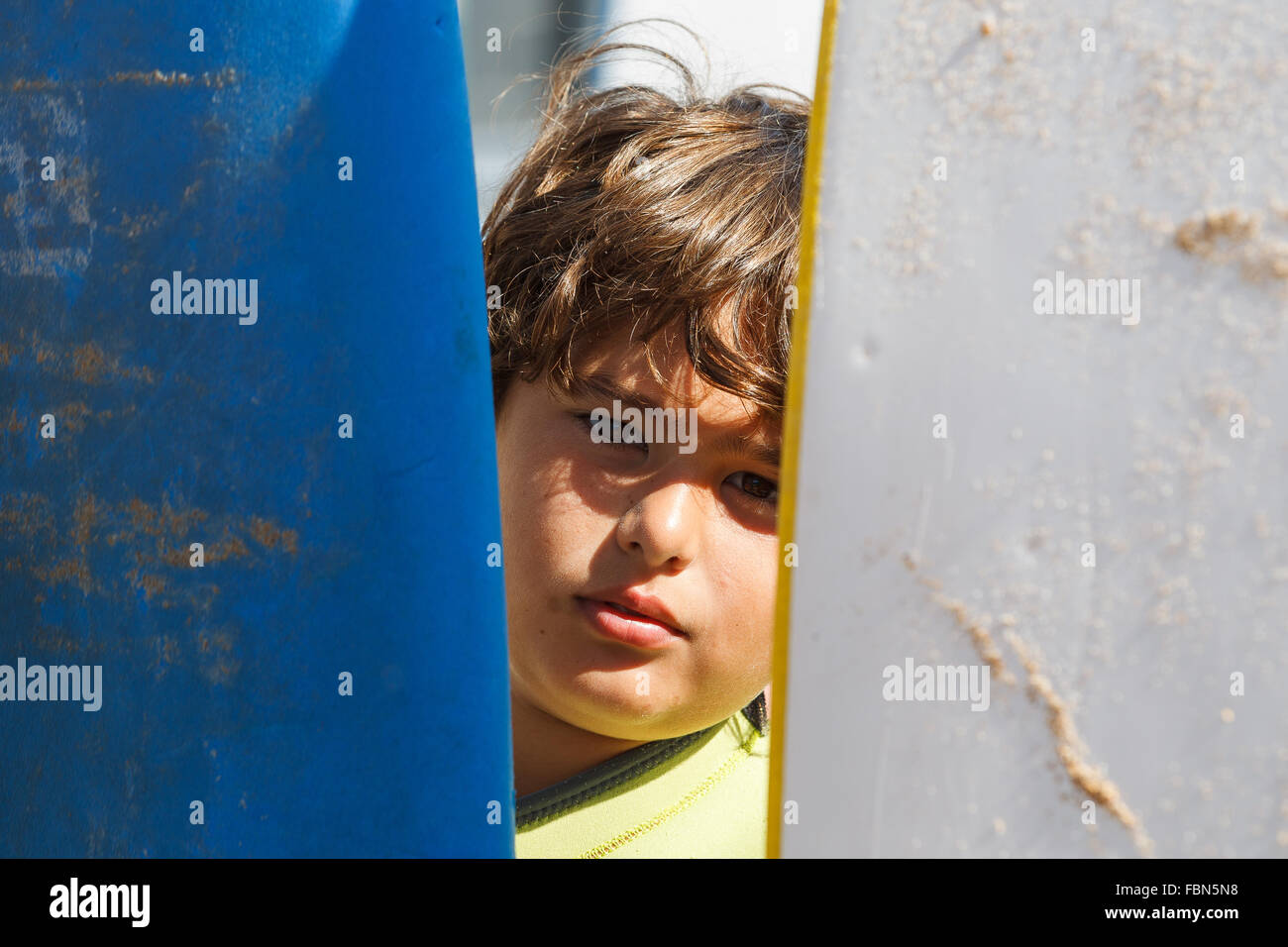 A boy with two surf boards, Valdearenas Beach, Liencres, Pielagos, Cantabria, Spain. Stock Photo