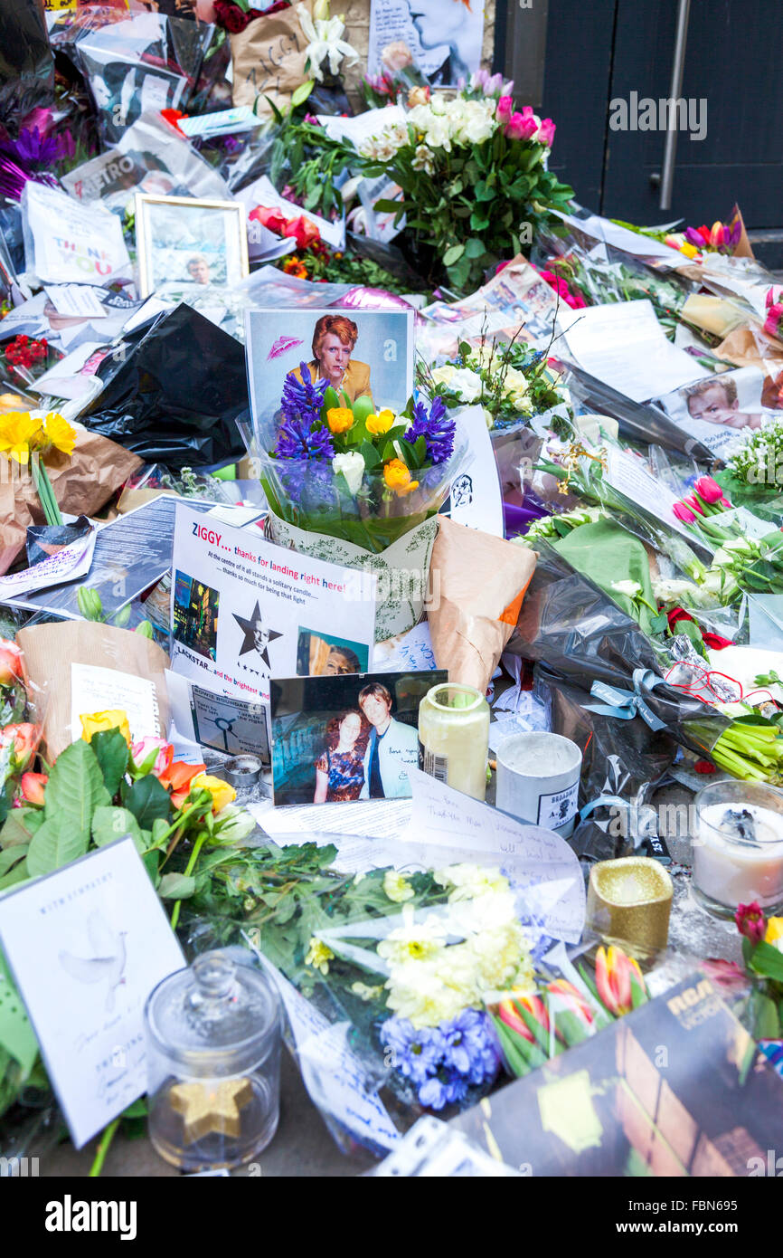 London, UK. 18th January 2015. Fans lay flowers and leave messages on Heddon Street after the unexpected passing of musician and actor David Bowie on 10th January. The shrine marks the location of the cover photograph of Bowie’s 1972 album The Rise and Fall of Ziggy Stardust. Credit:  Nathaniel Noir/Alamy Live News Stock Photo