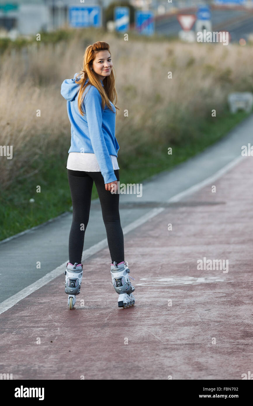 A caucasian young woman practicing inline skating in Maliaño, Cantabria, Spain. Stock Photo