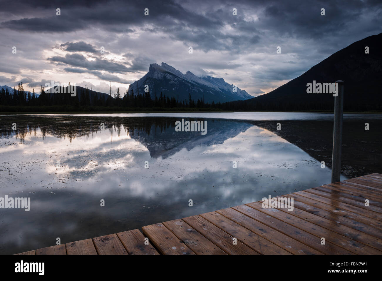 The dock by Vermilion Lakes on a stormy evening, in Banff town, Banff National Park, Alberta, Canada (Canadian Rocky Mountains). Stock Photo