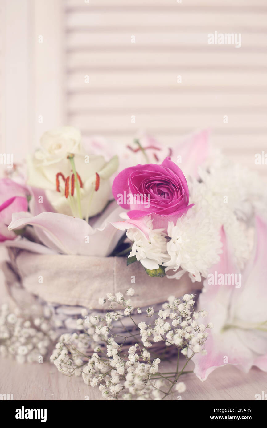 Beautiful bouquet of flowers in basket on wooden background, Valentines ...