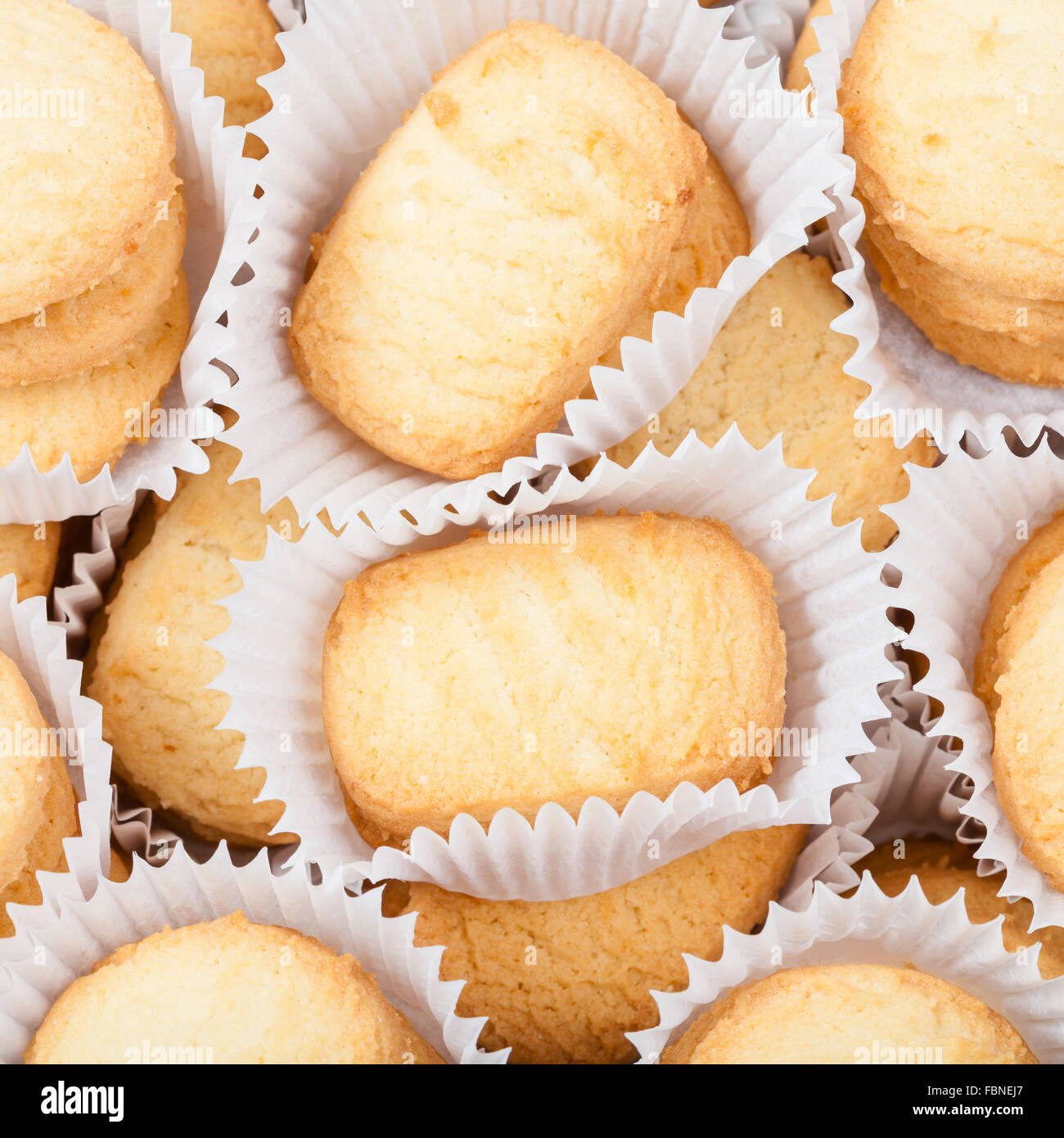 many sweet Butter Shortbread Biscuits in white semi- parchment paper Stock Photo