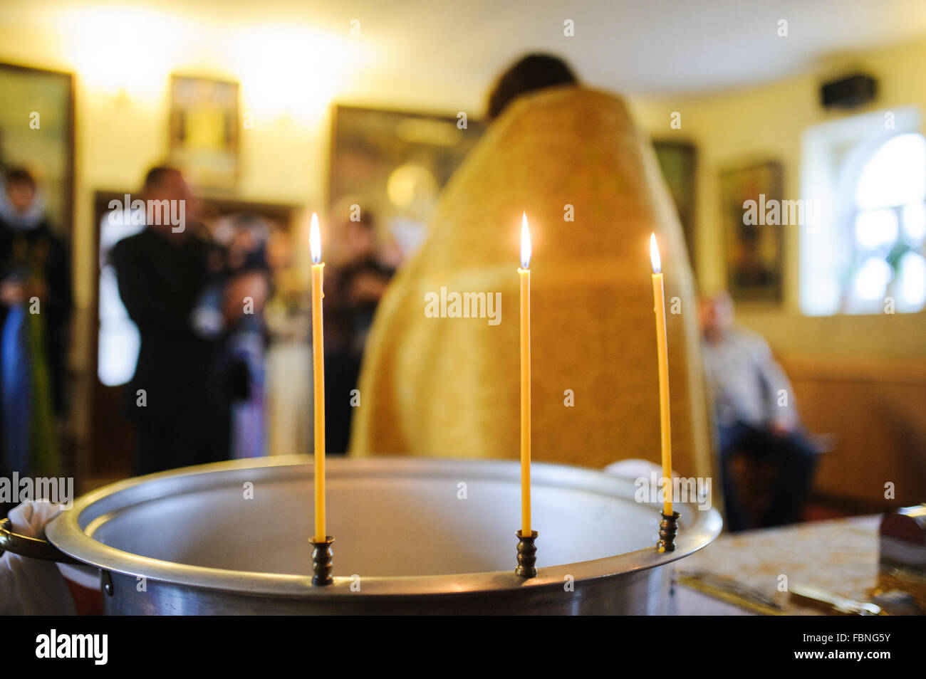 three burning thin candle during christening baptism Stock Photo Alamy