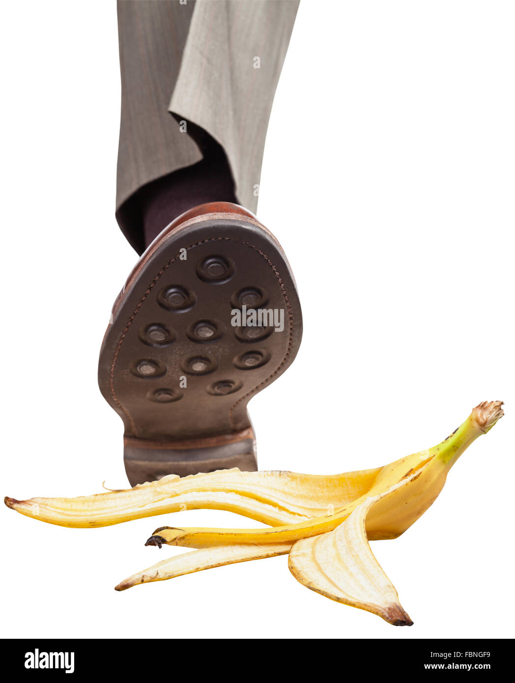 male leg in the right brown shoe stepping on banana peel isolated on ...