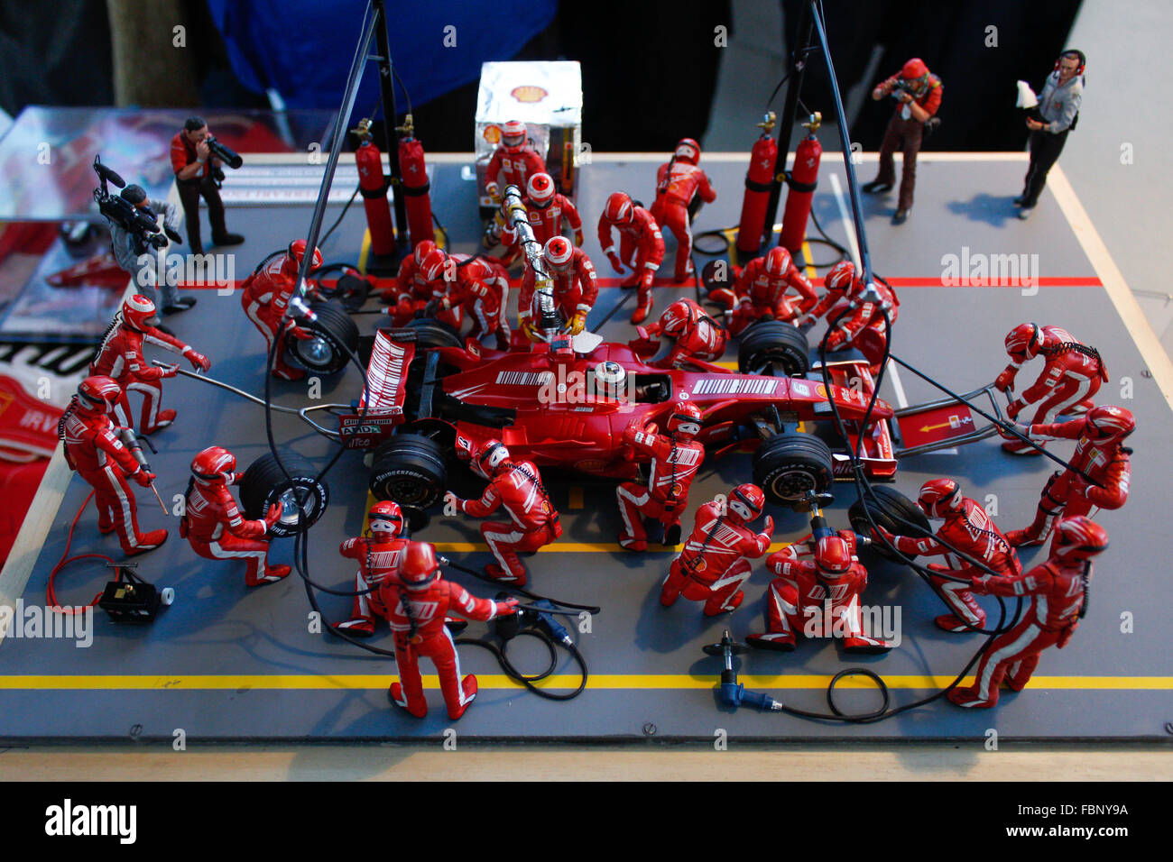 Torino, Italy. 17th Jan, 2016. A model of the moment at the Pit Stop Ferrari in Formula One with men pulling it while press capturing photos of it during modeling exhibition at Grugliasco, near Torino, a weekend dedicated to the static and dynamic modeling. © Cycle For Water Campaign/Alamy Live News Stock Photo