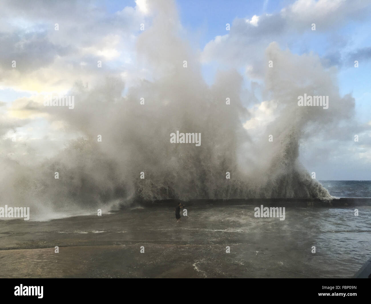 Havana, Cuba. 17th Jan, 2016. Man filming huge waves ''up close and personal''with his GoPro camera. El Nino waves as 30 metres high floaded whole Malecon boardwalk and part of Vedado in Havana, Cuba © Diana Mrazikova/ZUMA Wire/ZUMAPRESS.com/Alamy Live News Stock Photo
