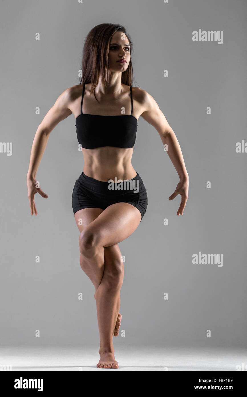 Beautiful fitness woman. Athletic girl on the gray background Stock Photo