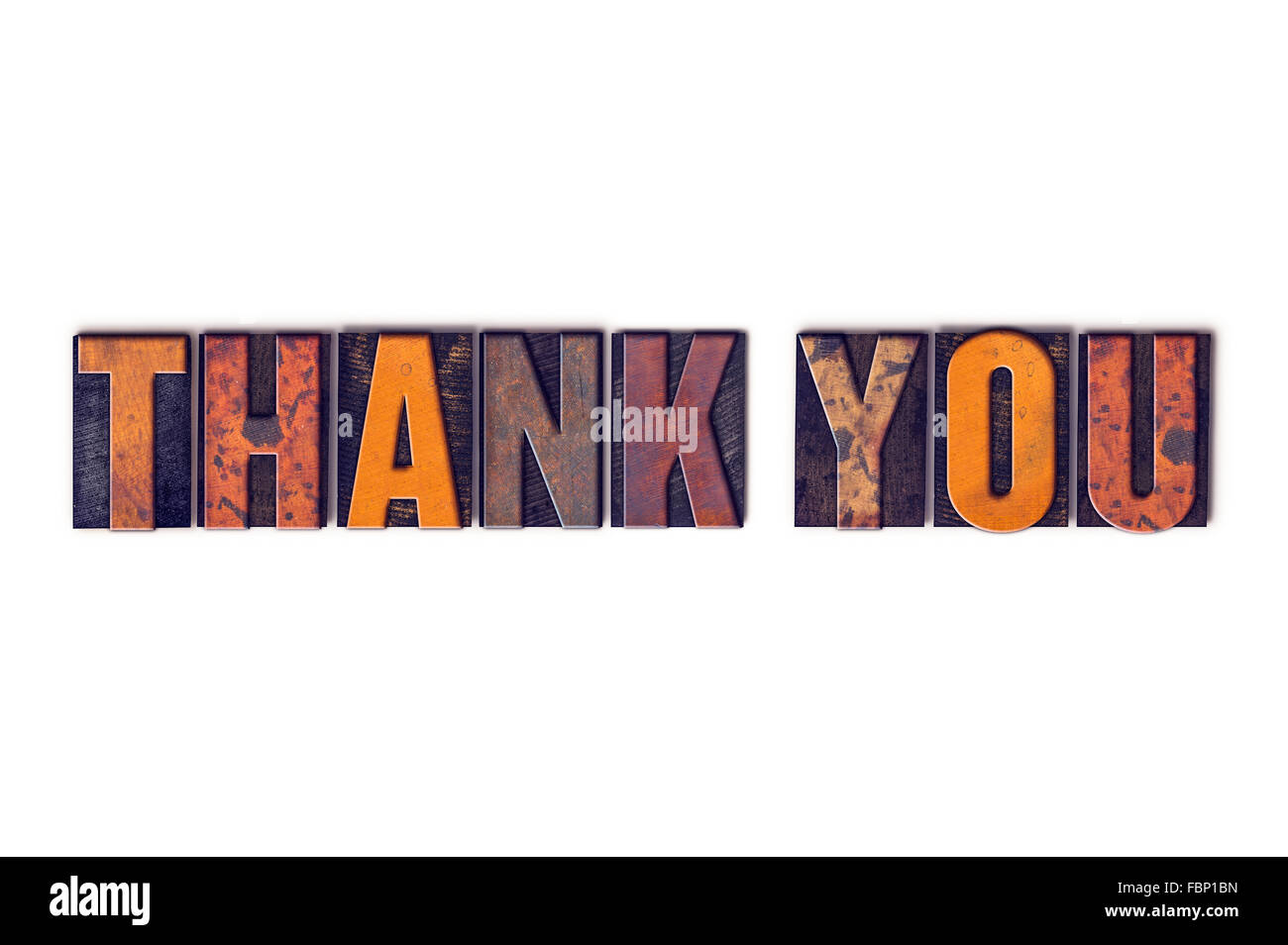 The word "Thank You" written in isolated vintage wooden letterpress type on a white background. Stock Photo