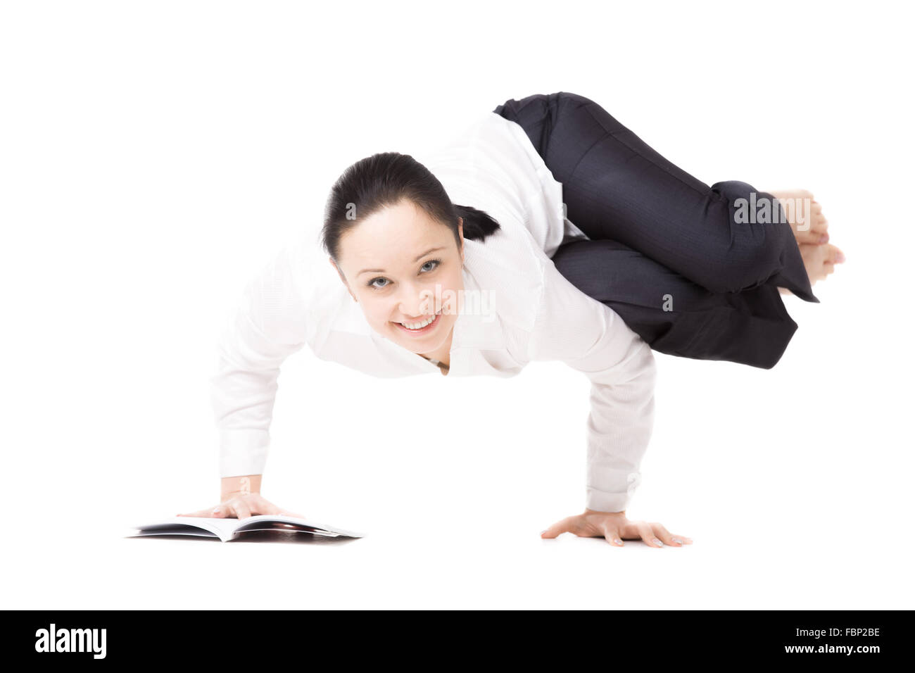 Business, study, healthy lifestyle. Smiling young female office employee in formalwear reading book, doing fitness exercises Stock Photo