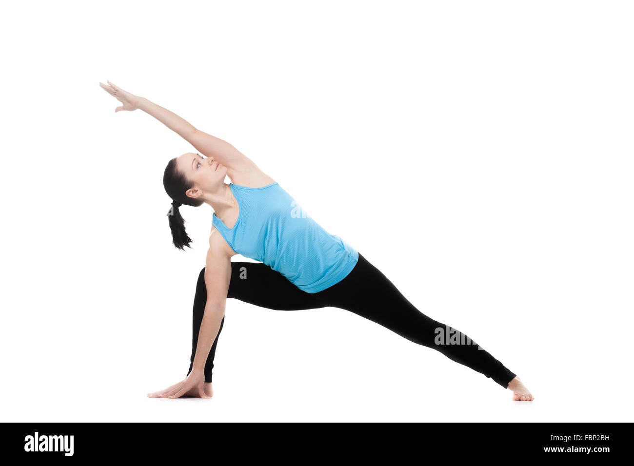 Yoga girl on white background exercises in yoga posture Utthita Parsva Konasana (Extended Side Angle Pose) Stock Photo