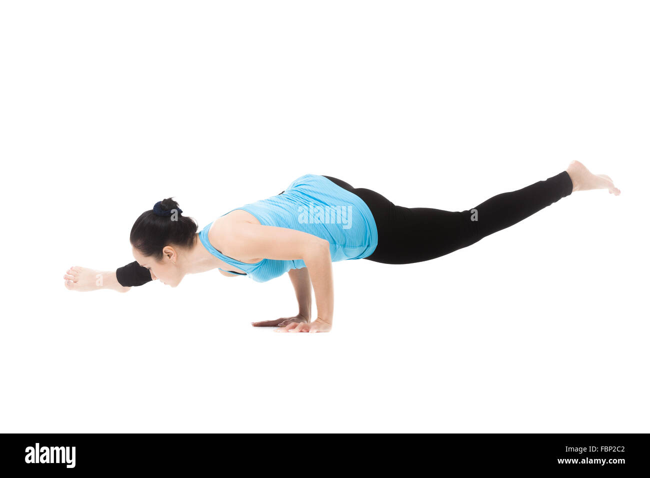 Sporty yogi girl doing exercises, asana Eka Pada Koundinyasana, twisted one legged arm balance, Yoga Pose, isolated Stock Photo