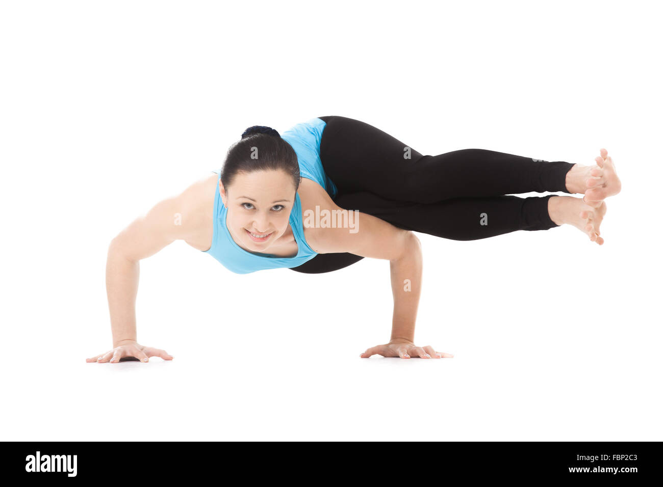 Sporty yogi girl doing exercises, asana Dwi Pada Koundinyasana, two-legged variation of Sage Koundinya Yoga Pose, isolated Stock Photo