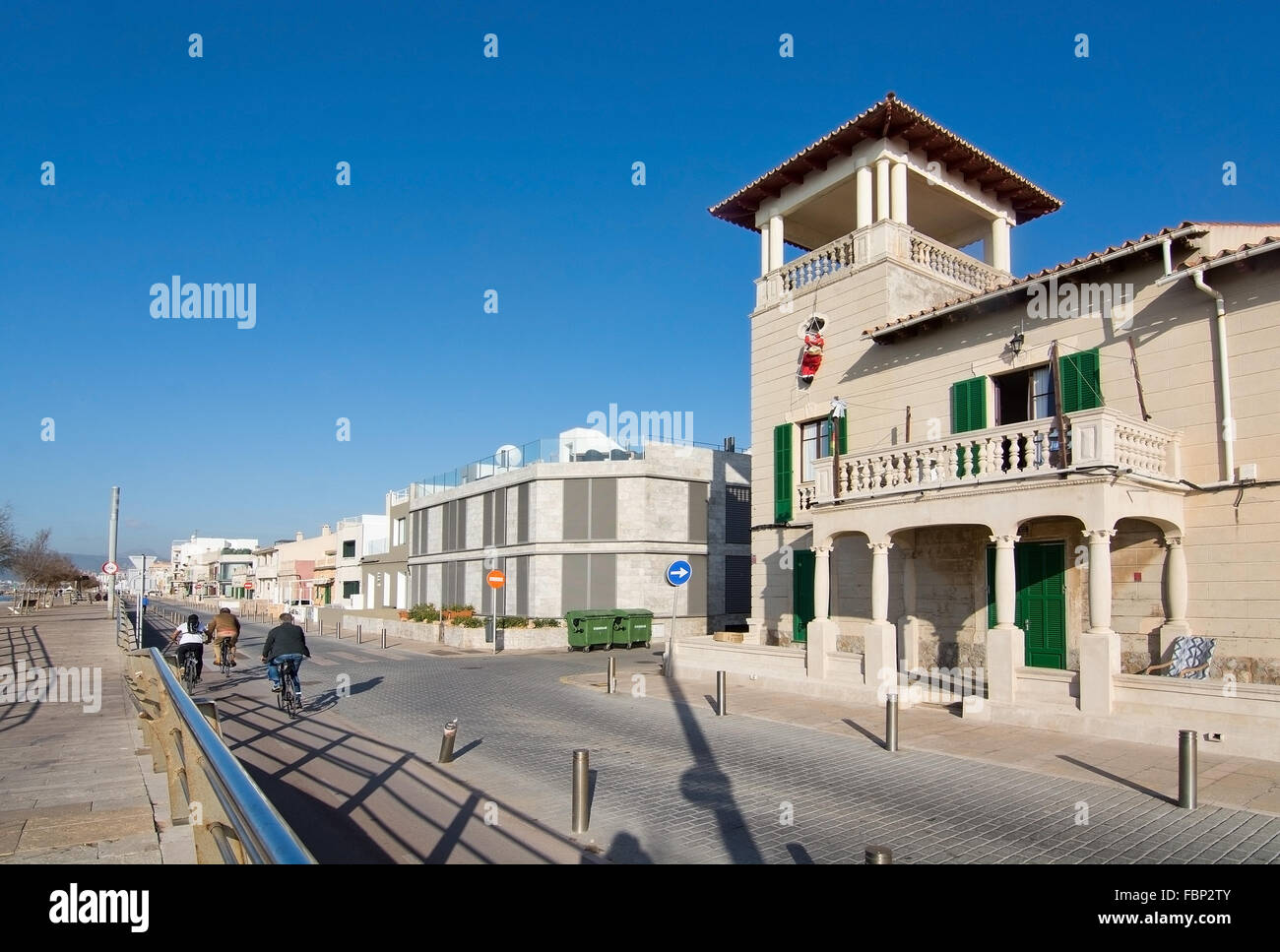 Building with Santa Claus hanging out from building and some bicyclists in Molinar, Palma de Mallorca, Spain. Stock Photo