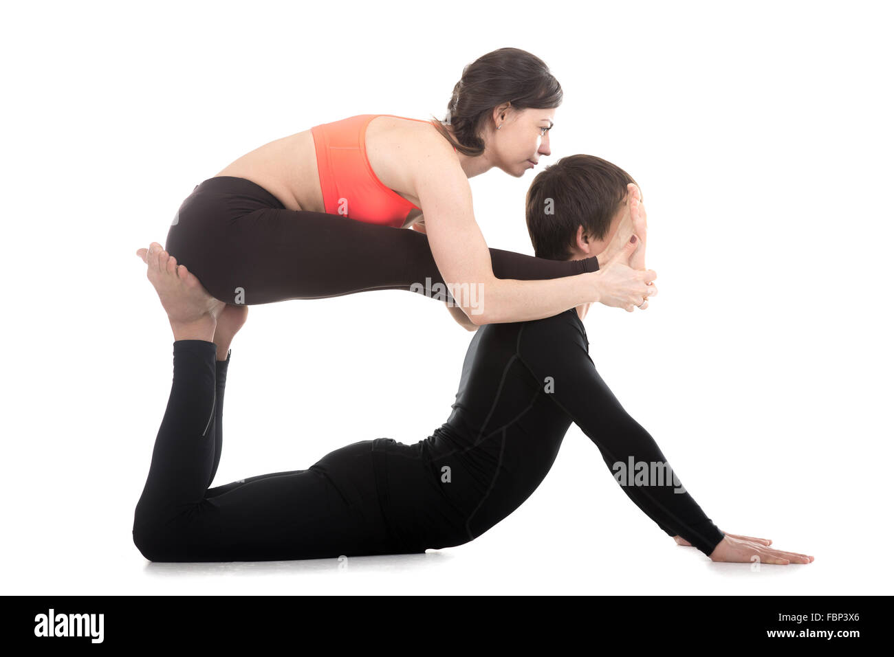 Photo Acro yoga, two sporty people practice yoga in pair, couple doing  stretching exer