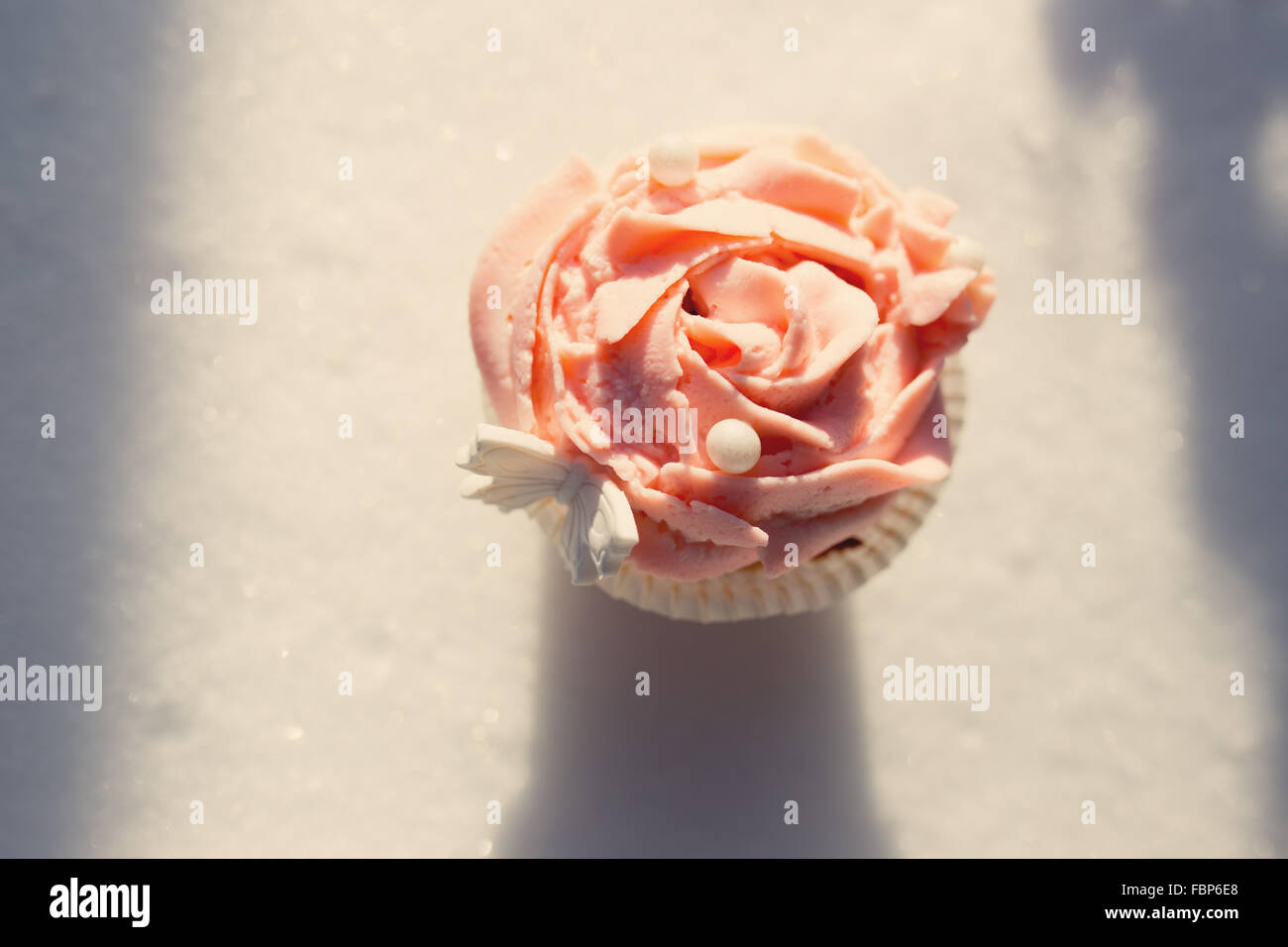 Outdoor photo of cupcake decorated with a sugar butterfly. Cupca Stock Photo