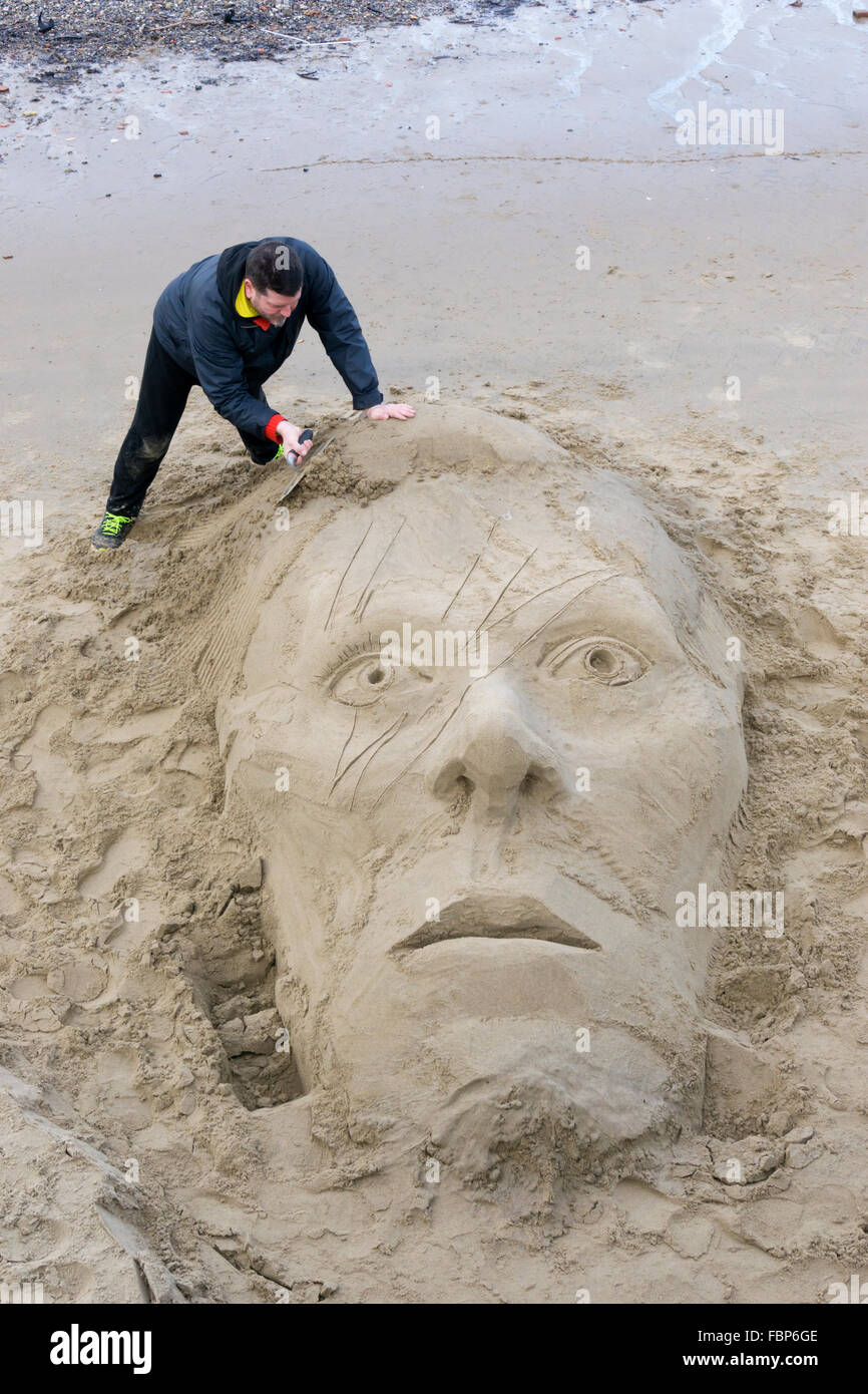 A David Bowie tribute sand sculpture next to the River Thames on the South Bank, London. Stock Photo