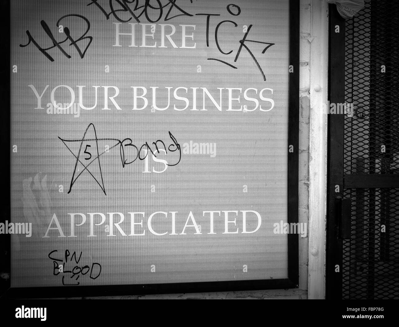 Ironically defaced sign with graffiti stating Here Your Business is Appreciated Stock Photo