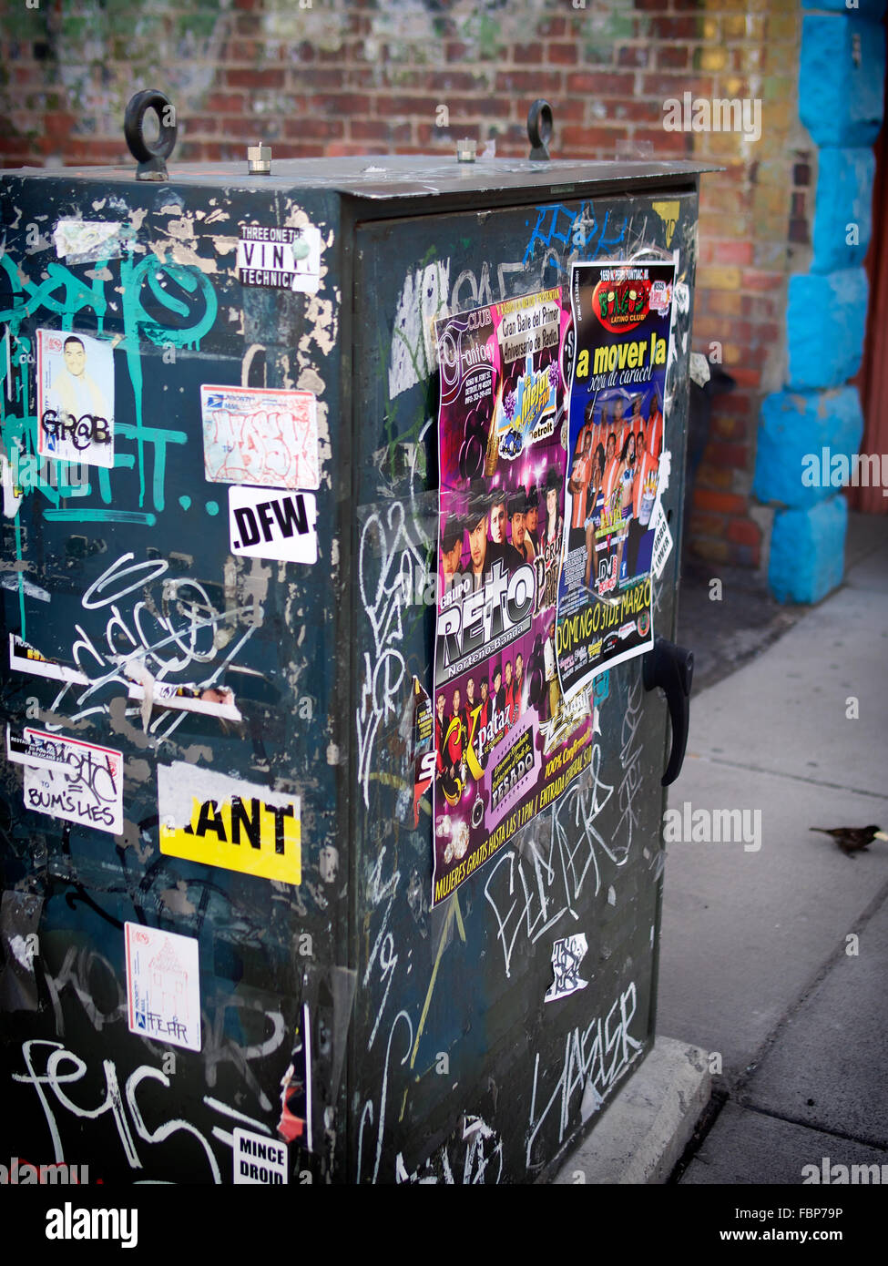 Detail view of electrical juntion box covered with playbills and graffiti in Mexicantown Detroit Stock Photo