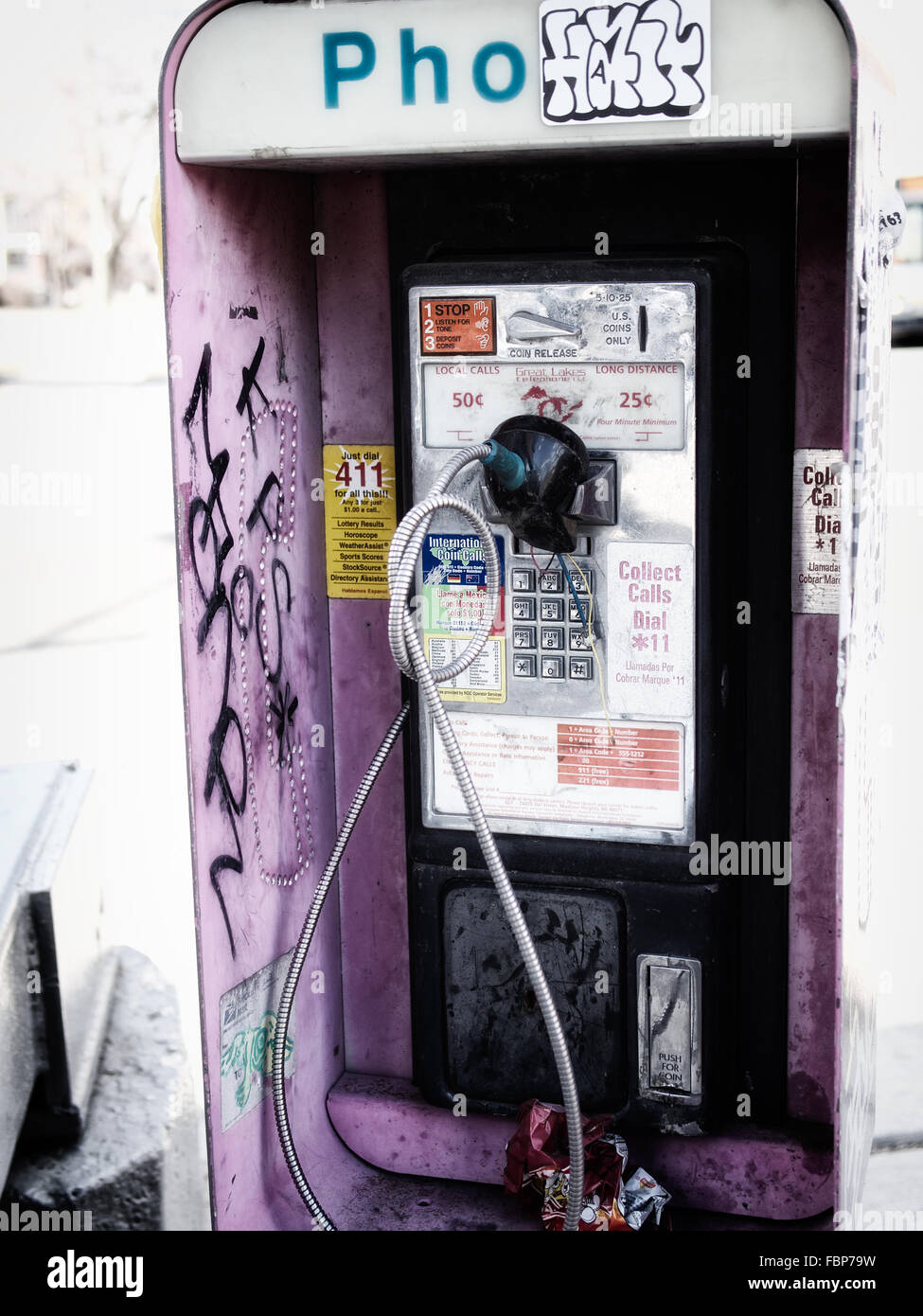 Remains of phone booth in Mexicantown Detroit that has been broken and painted with graffiti Stock Photo