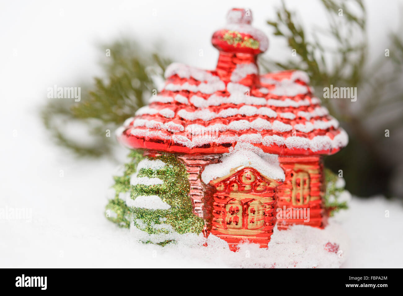 Christmas house toy with decoration in snow at winter day. Close Stock Photo