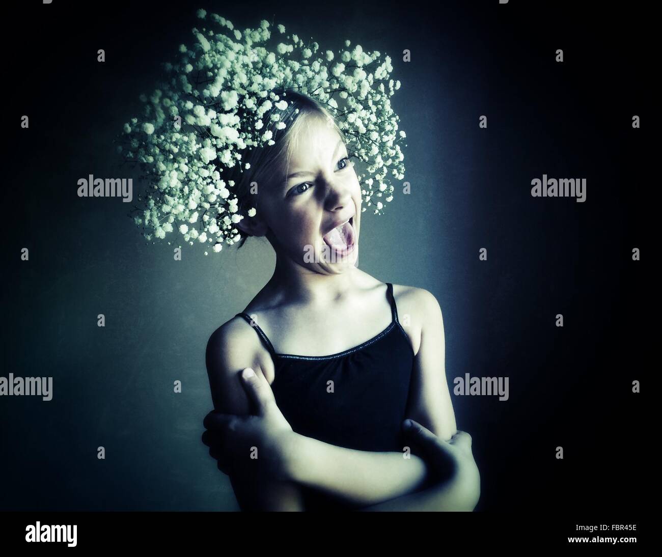 Girl Wearing Flowers Screaming Against Wall Stock Photo - Alamy