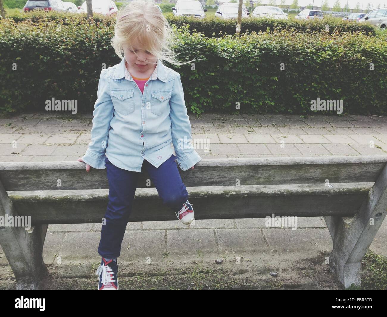 Girl sitting on bench hi-res stock photography and images - Alamy
